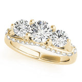 Gold ring with three circular diamonds on a white background