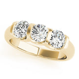 Gold ring with three diamonds on a white background