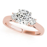 Rose gold ring with three diamonds on a white background