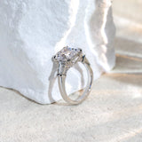 Silver ring with a large diamond on a white fabric background