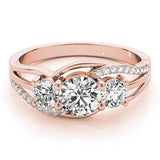 Rose gold ring with three diamonds on a white background