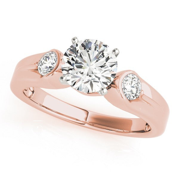 Rose gold ring with a large diamond and two smaller diamonds on a white background
