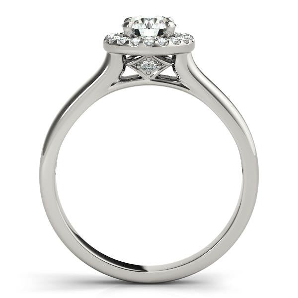 Round cut diamond halo engagement ring in platinum with pave side diamonds.