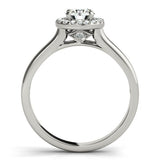 Round cut diamond halo engagement ring in platinum with pave side diamonds.