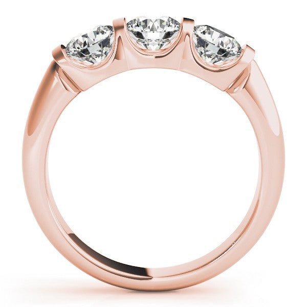 Rose gold ring with three clear gemstones on a white background