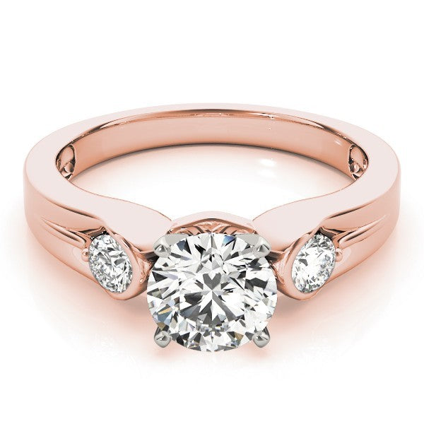 Rose gold ring with a large diamond and smaller diamonds on the sides against a white background