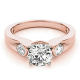 Rose gold ring with a large diamond and smaller diamonds on the sides against a white background