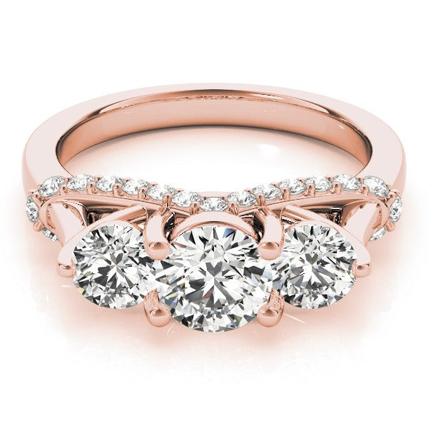 Rose gold ring with three large diamonds and smaller diamonds on a white background