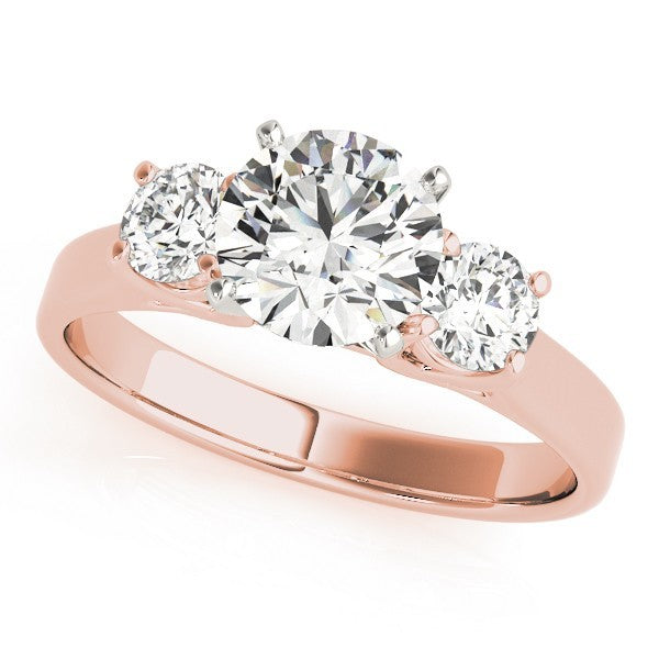 Rose gold ring with three clear gemstones on a white background