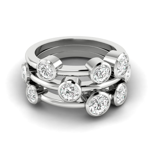 A hand wearing a stack of three gold rings, each with a round-cut diamond, with the ring's bubble design clearly visible.