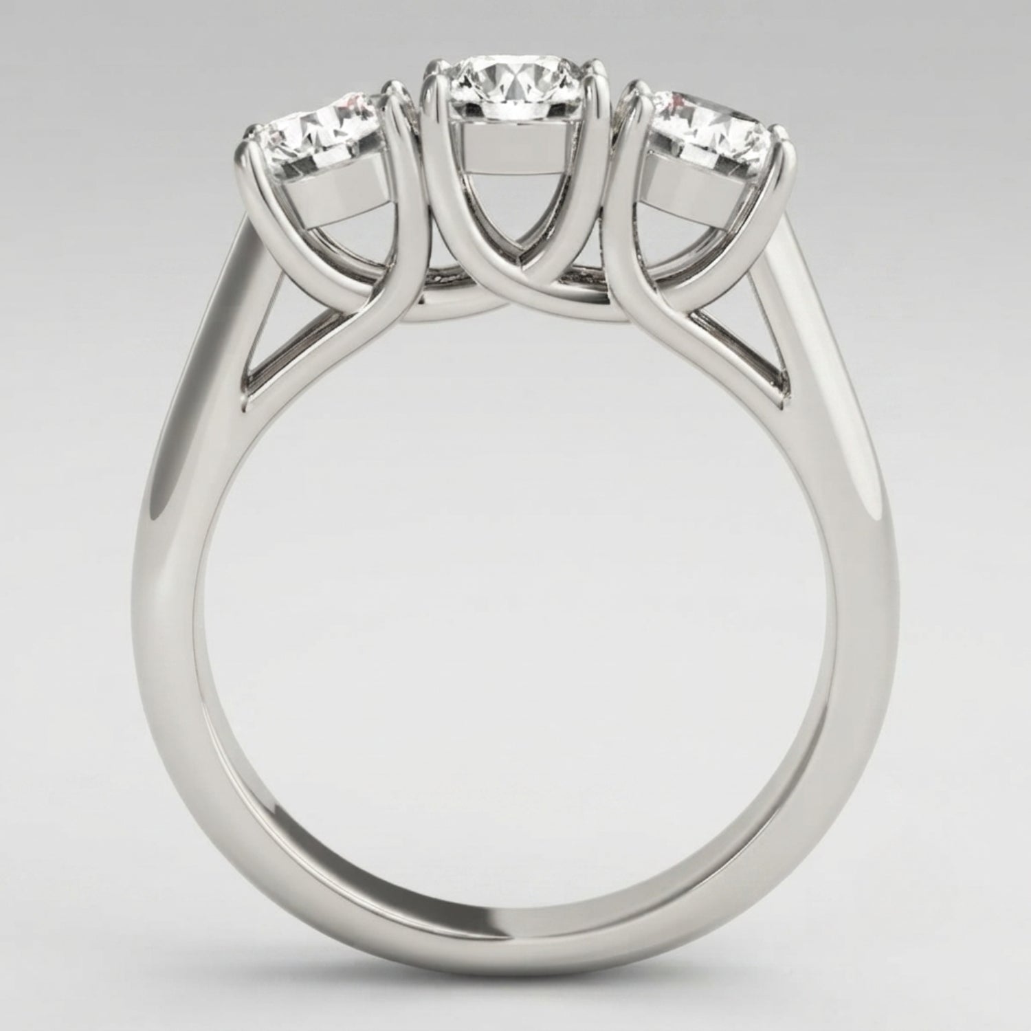 Timeless round-cut lab-grown diamond trilogy engagement ring with a high-polished finish and ethical luxury appeal.