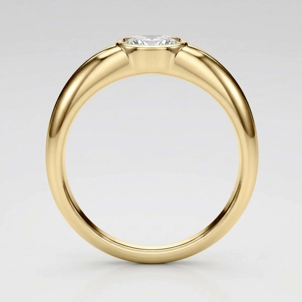 A yellow gold solitaire ring with a round brilliant-cut diamond set in a four-prong setting, shown on a light gray gradient background.